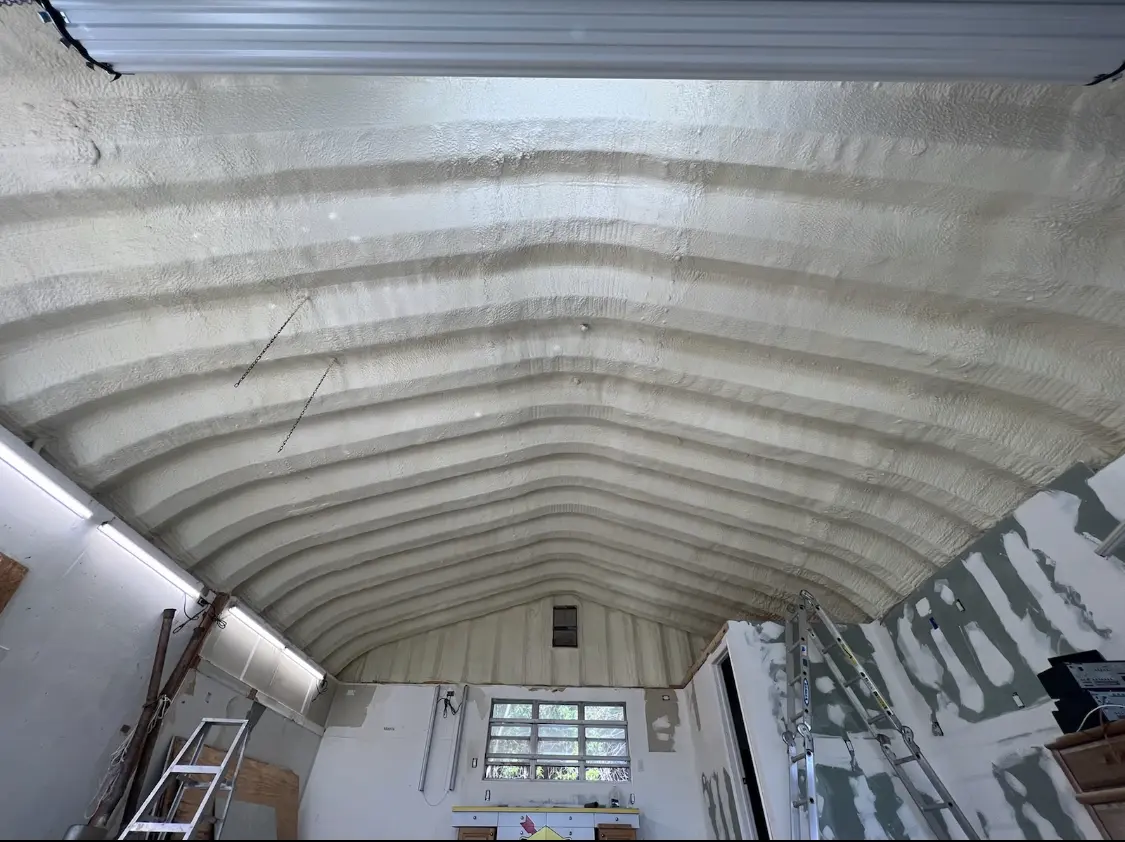Spray polyurethane foam applied to the underside of a metal roof deck in Franklin